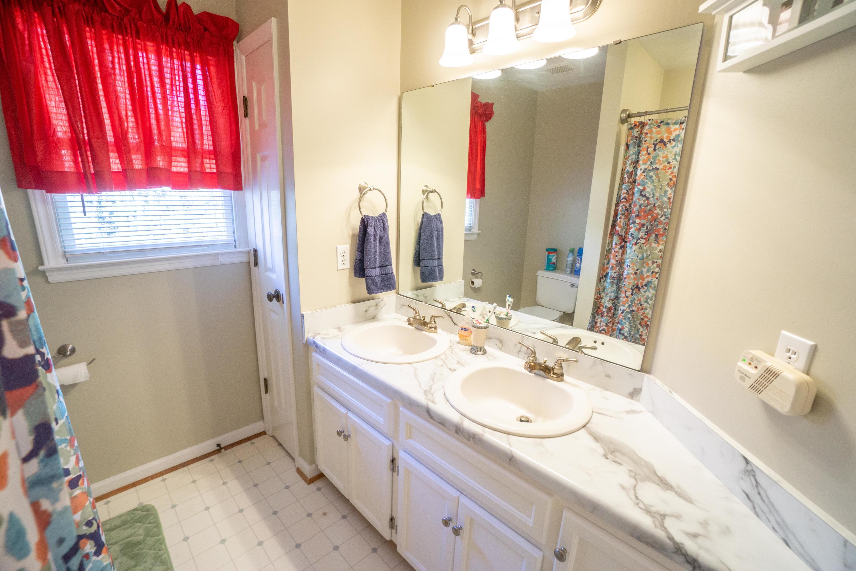 218 Oak Ridge Court Blue Ridge, VA 24064 - Photo 35 of 48 a bathroom with a double vanity sink and a mirror