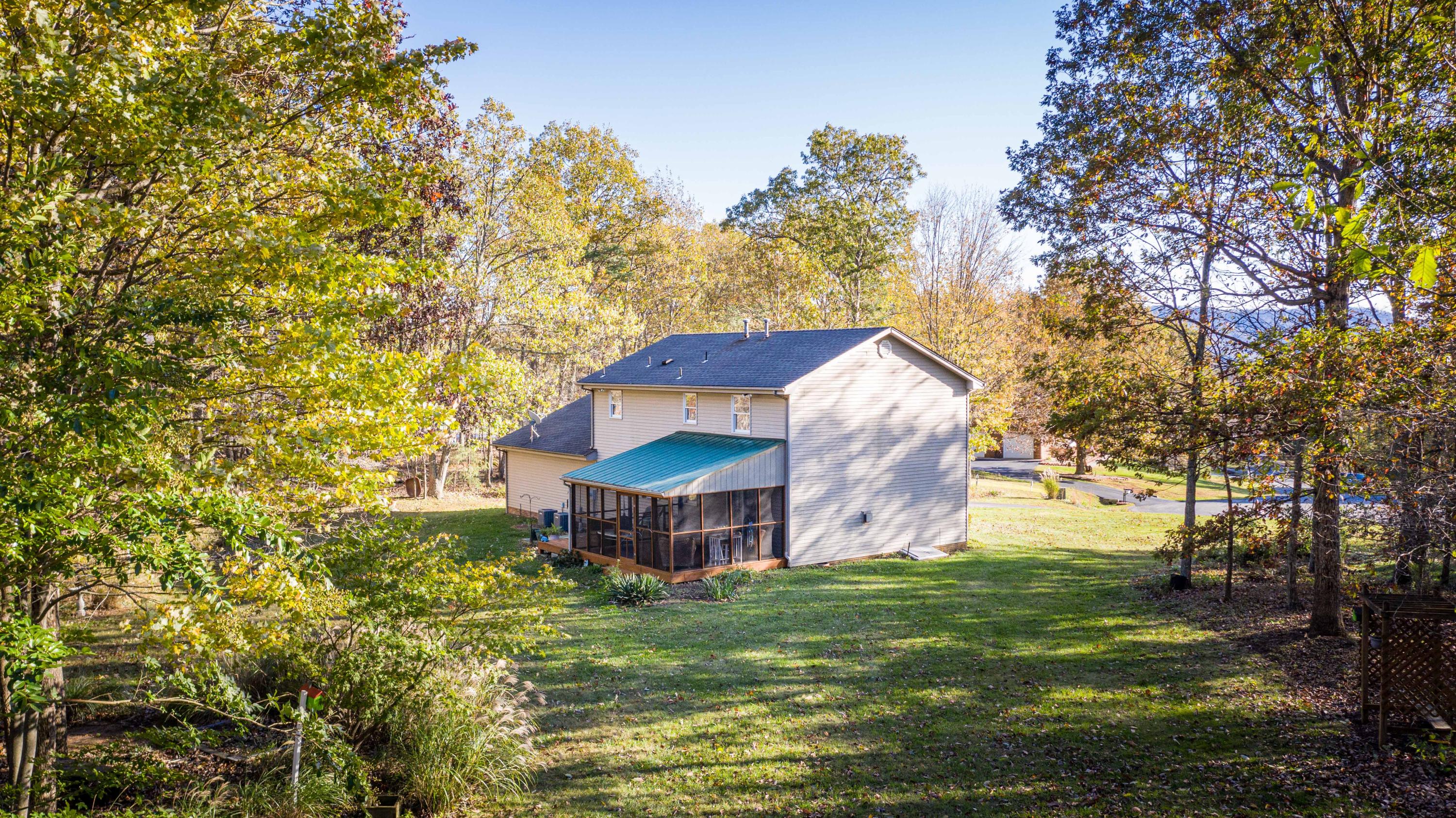 218 Oak Ridge Court Blue Ridge, VA 24064 - Photo 43 of 48 a view of a house with a yard and sitting area