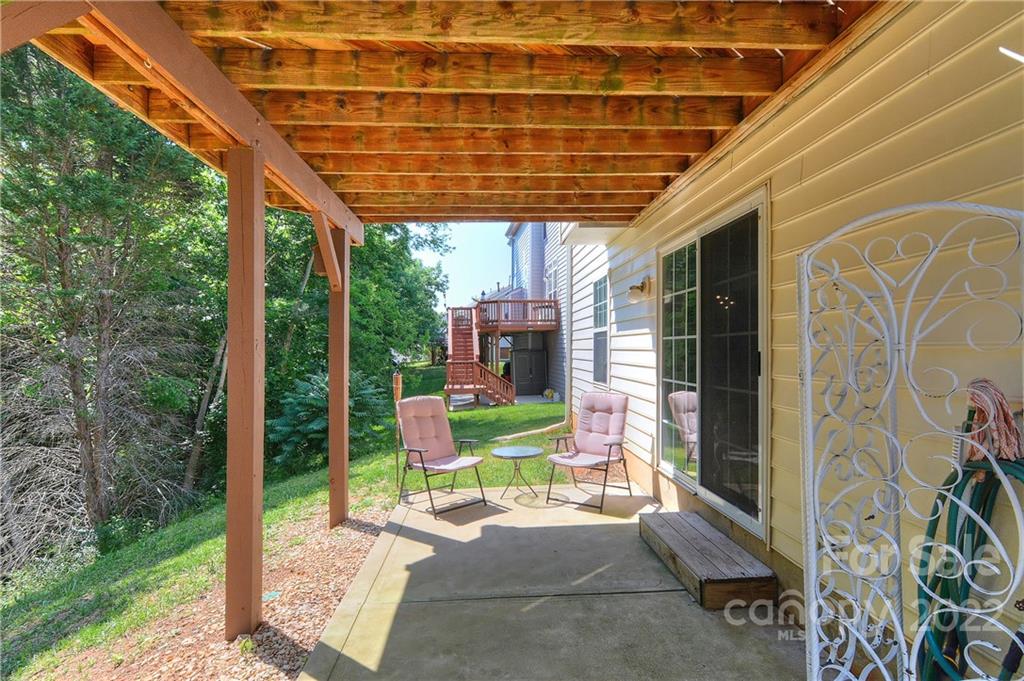 1421 Autumn Ridge Lane Fort Mill, SC 29708 - Photo 40 of 48 a view of a chair and table in the patio with a backyard