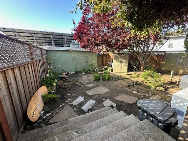 a backyard of a house with outdoor seating