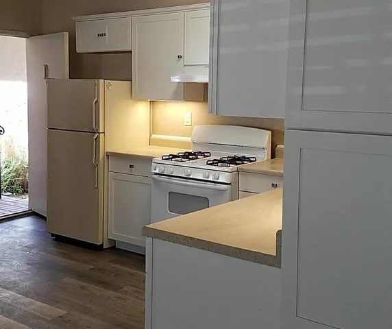 a kitchen with a stove and a refrigerator