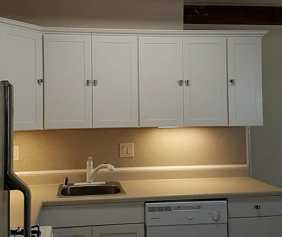 a kitchen with a sink and cabinets