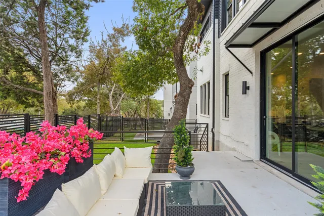 a view of a patio with couches table and chairs and potted plants