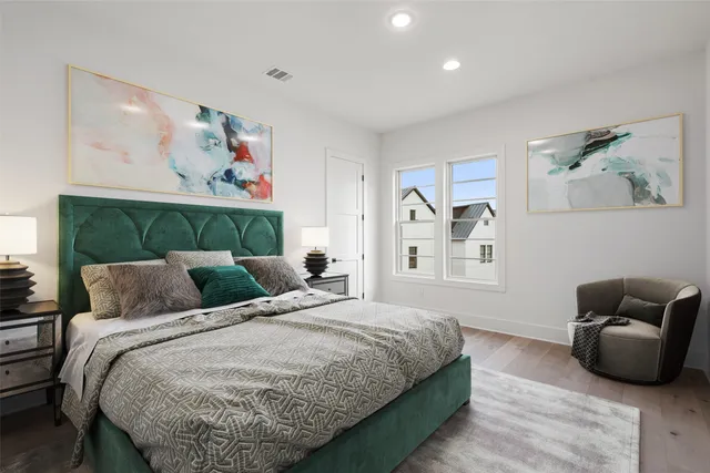 a bedroom with a bed and wooden floor