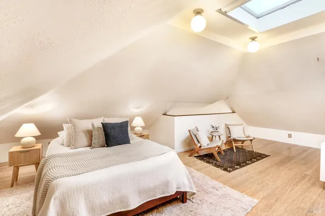 a bedroom with a bed and lamp