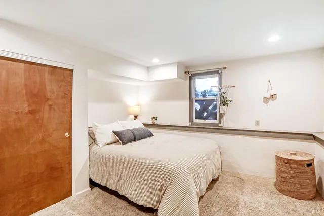 a bedroom with a bed and a large mirror