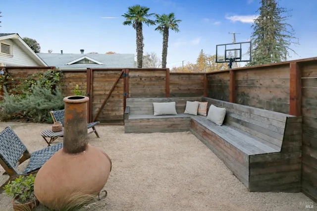 a view of roof deck with two chairs and a potted plant