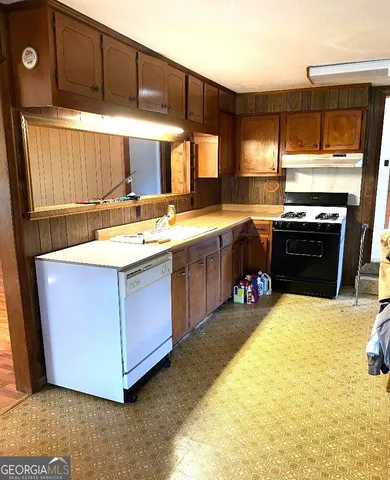a kitchen with a sink and a stove