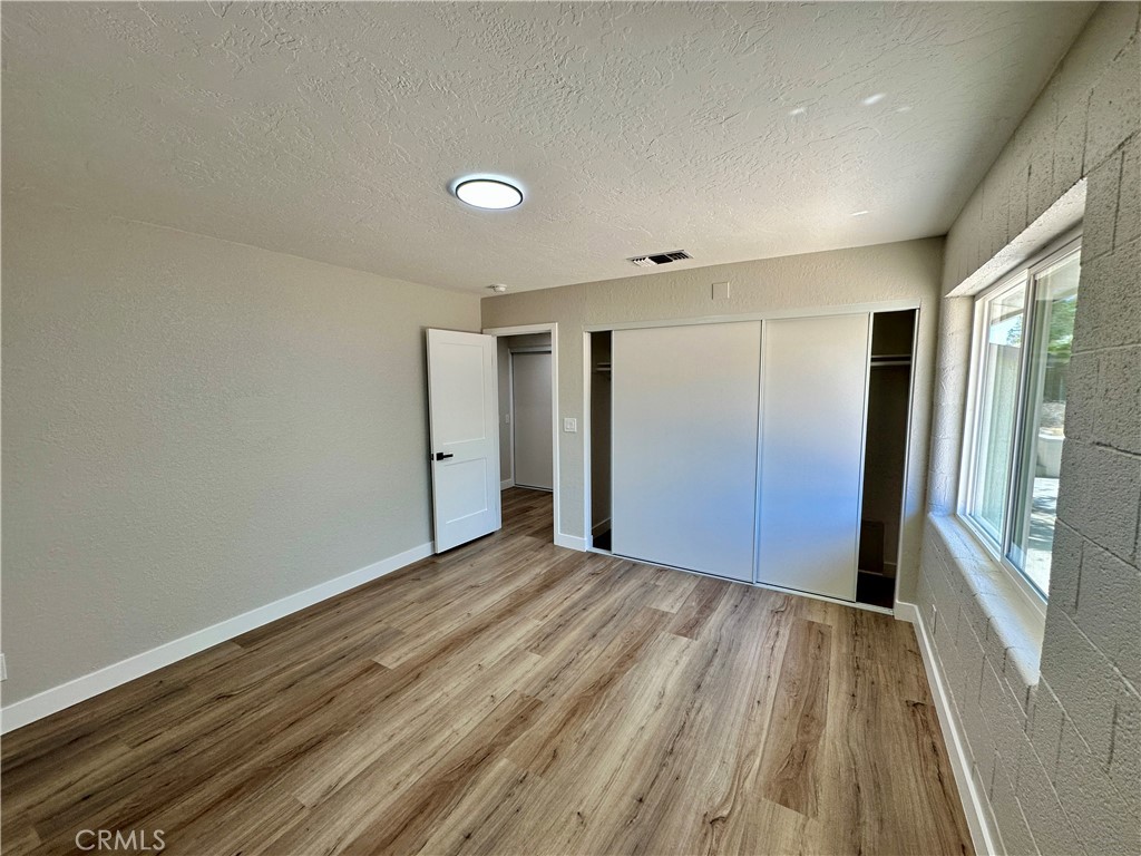 625 Tamarack Road Pinon Hills, CA 92372 - Photo 12 of 27 a view of empty room with wooden floor and fan