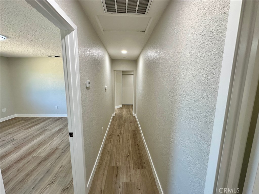 625 Tamarack Road Pinon Hills, CA 92372 - Photo 13 of 27 a view of hallway with wooden floor