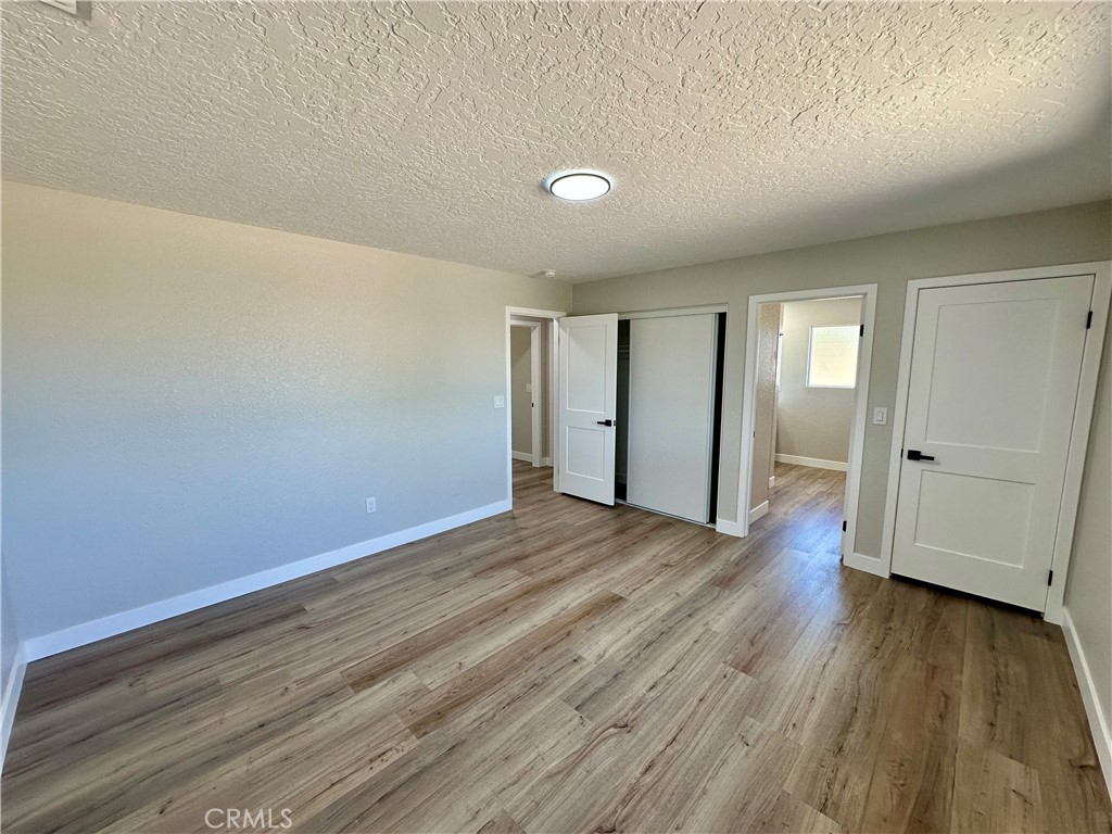 625 Tamarack Road Pinon Hills, CA 92372 - Photo 15 of 27 wooden floor in an empty room with a window