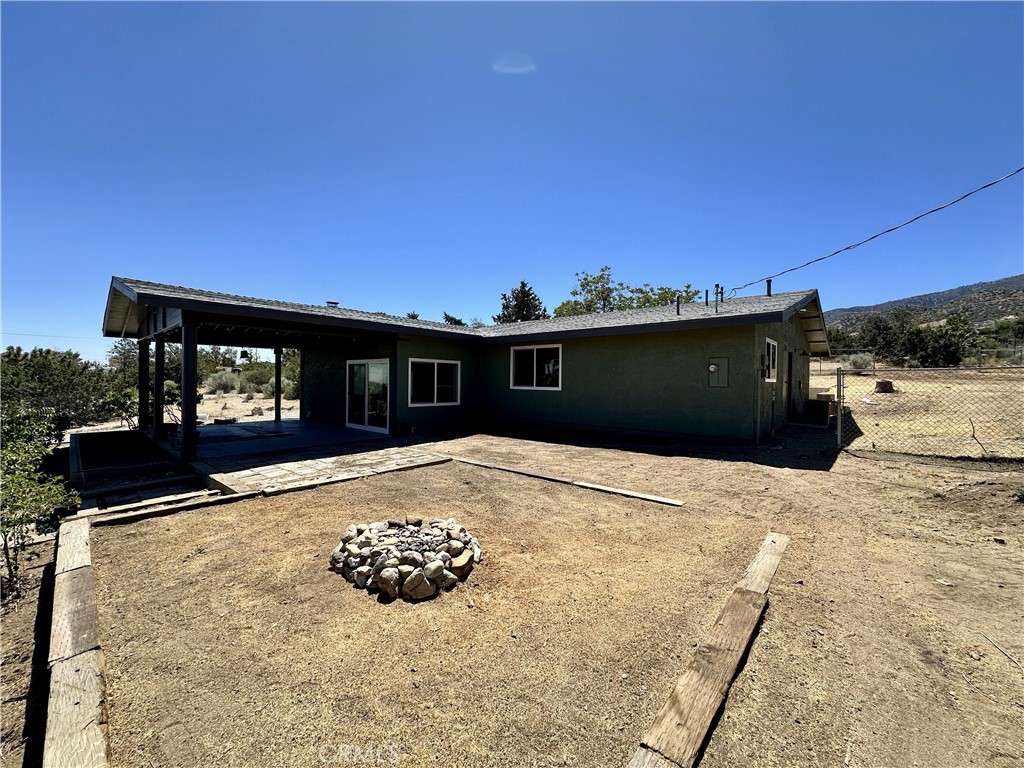 625 Tamarack Road Pinon Hills, CA 92372 - Photo 2 of 27 a view of a terrace with a flat screen tv