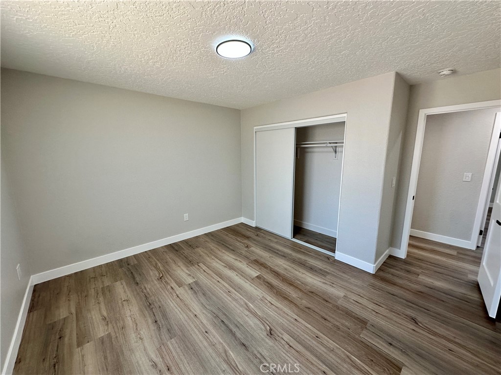 625 Tamarack Road Pinon Hills, CA 92372 - Photo 22 of 27 a view of an empty room and wooden floor