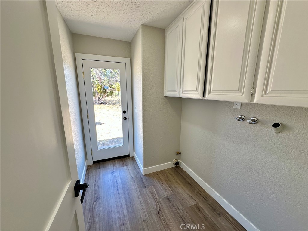 625 Tamarack Road Pinon Hills, CA 92372 - Photo 23 of 27 a view of storage and utility room with wooden floor