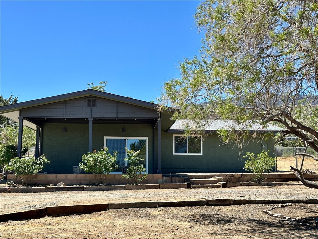 625 Tamarack Road Pinon Hills, CA 92372 - Photo 27 of 27 a front view of a house with garden