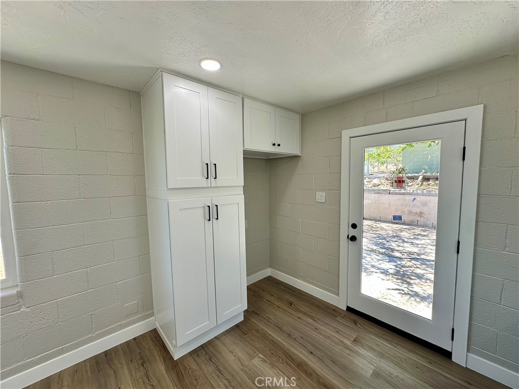 625 Tamarack Road Pinon Hills, CA 92372 - Photo 4 of 27 a view of an empty room with wooden floor and a window