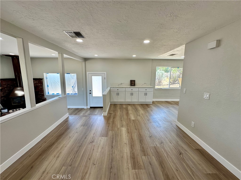 625 Tamarack Road Pinon Hills, CA 92372 - Photo 7 of 27 a view of wooden floor and windows in an empty room