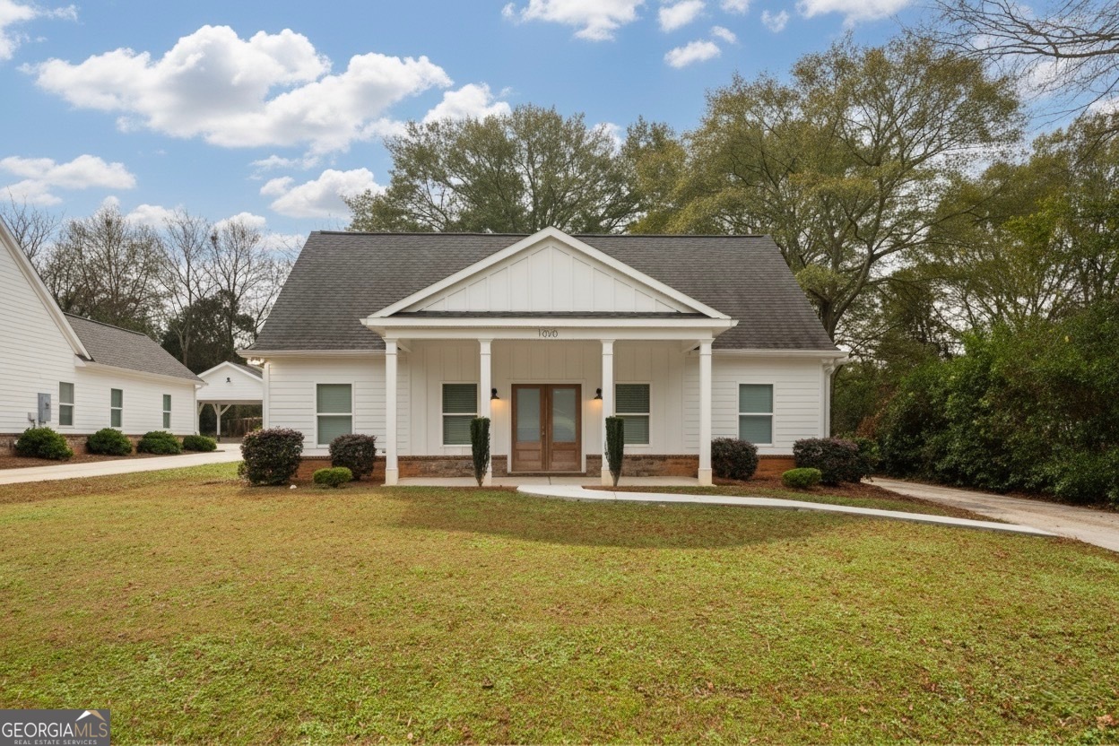 a front view of a house with swimming pool and porch