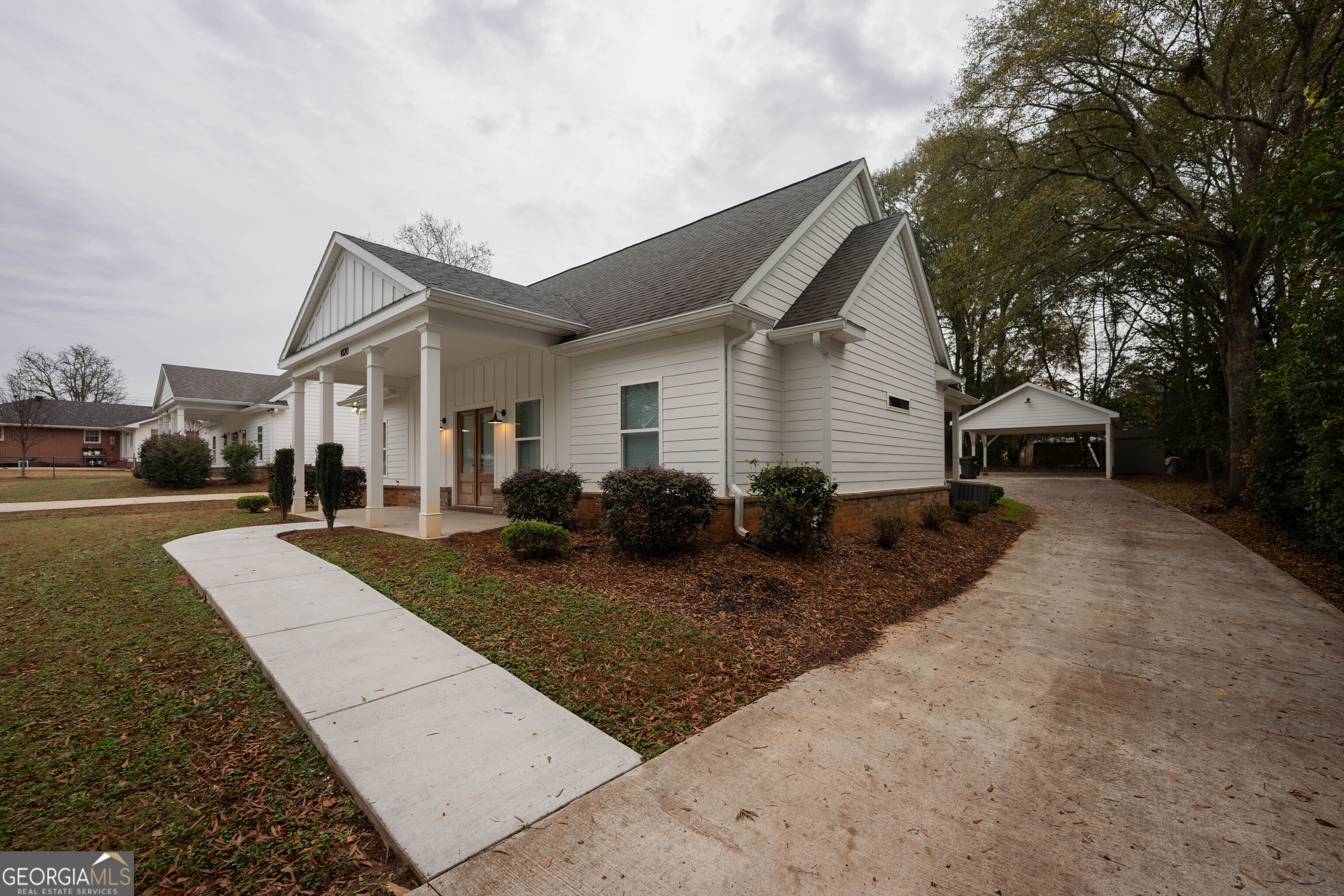 1020 Bell Circle Madison, GA 30650 - Photo 16 of 17 a front view of house with yard and trees in the background