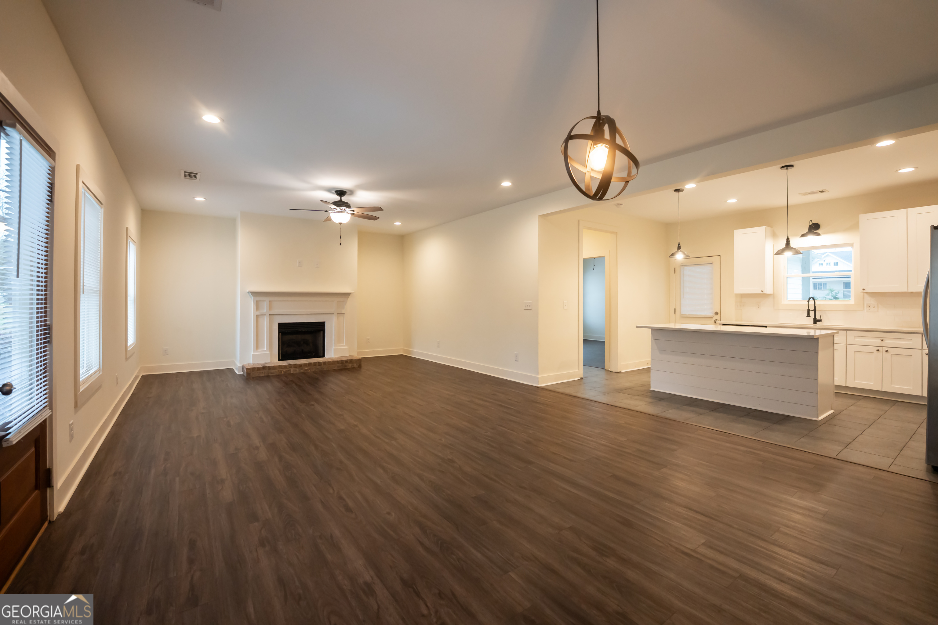1020 Bell Circle Madison, GA 30650 - Photo 2 of 17 a view of a kitchen with a sink and a refrigerator
