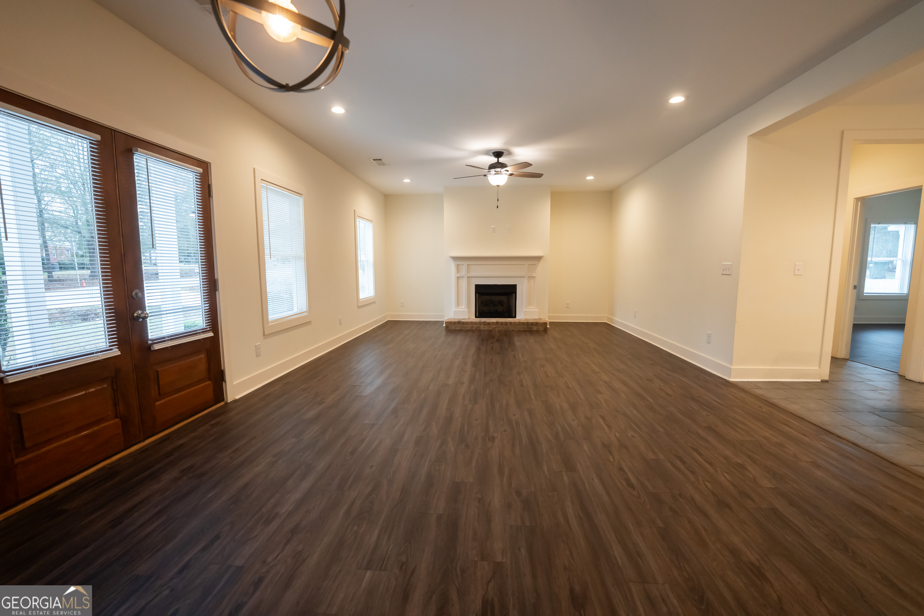 1020 Bell Circle Madison, GA 30650 - Photo 3 of 17 a view of empty room with wooden floor and fan