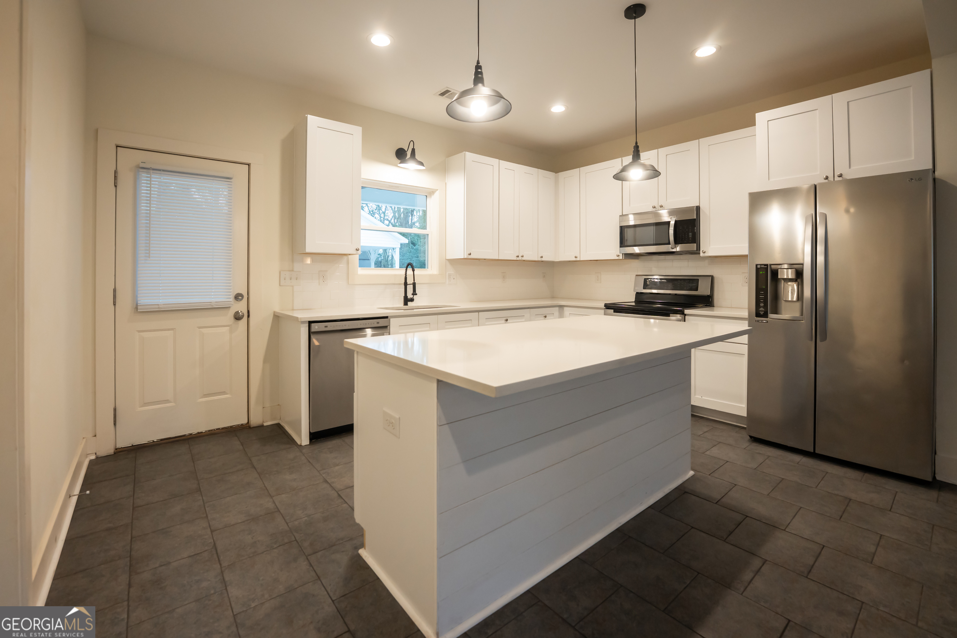 1020 Bell Circle Madison, GA 30650 - Photo 5 of 17 a kitchen with a sink appliances and cabinets