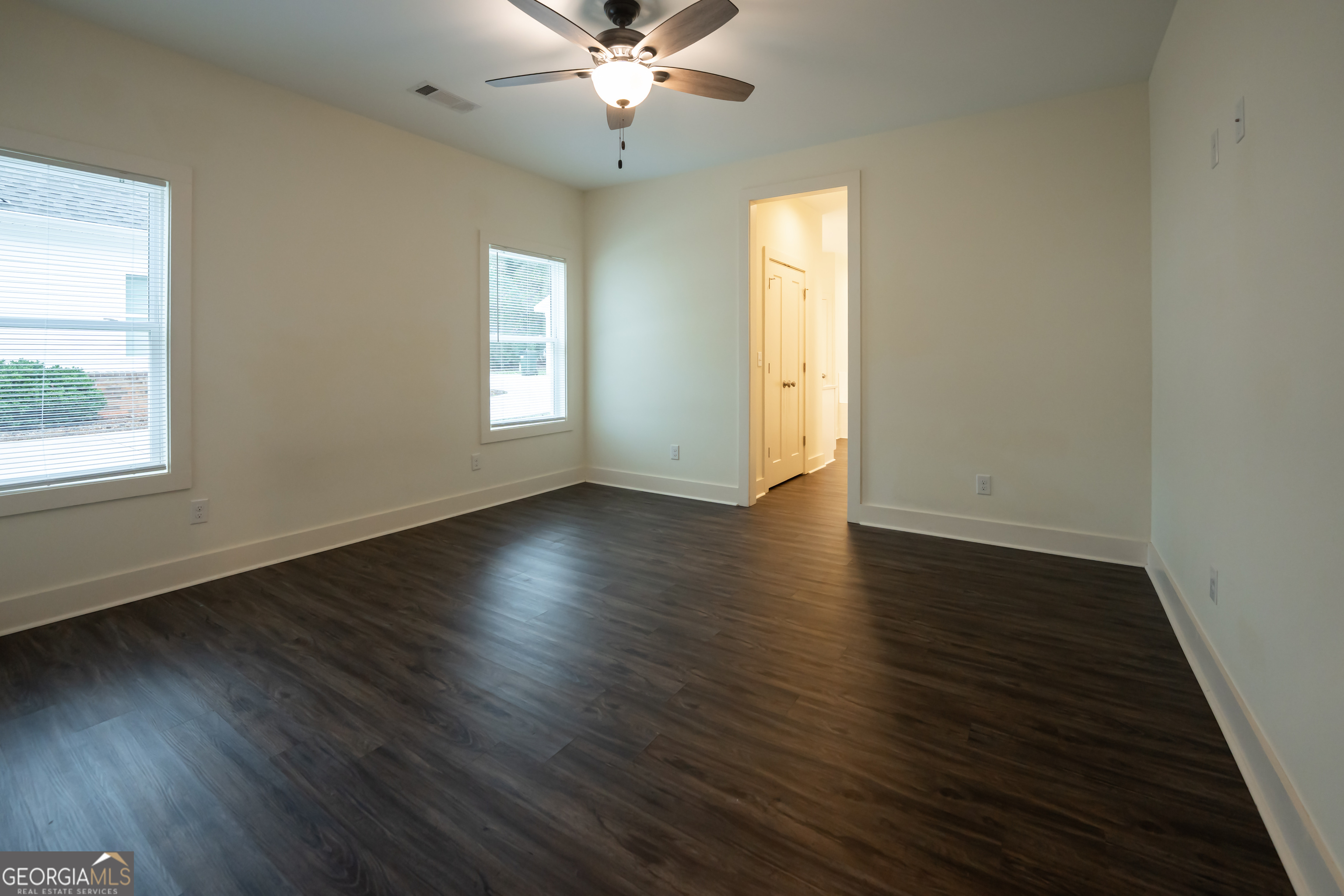 1020 Bell Circle Madison, GA 30650 - Photo 7 of 17 a view of an empty room with wooden floor and a window