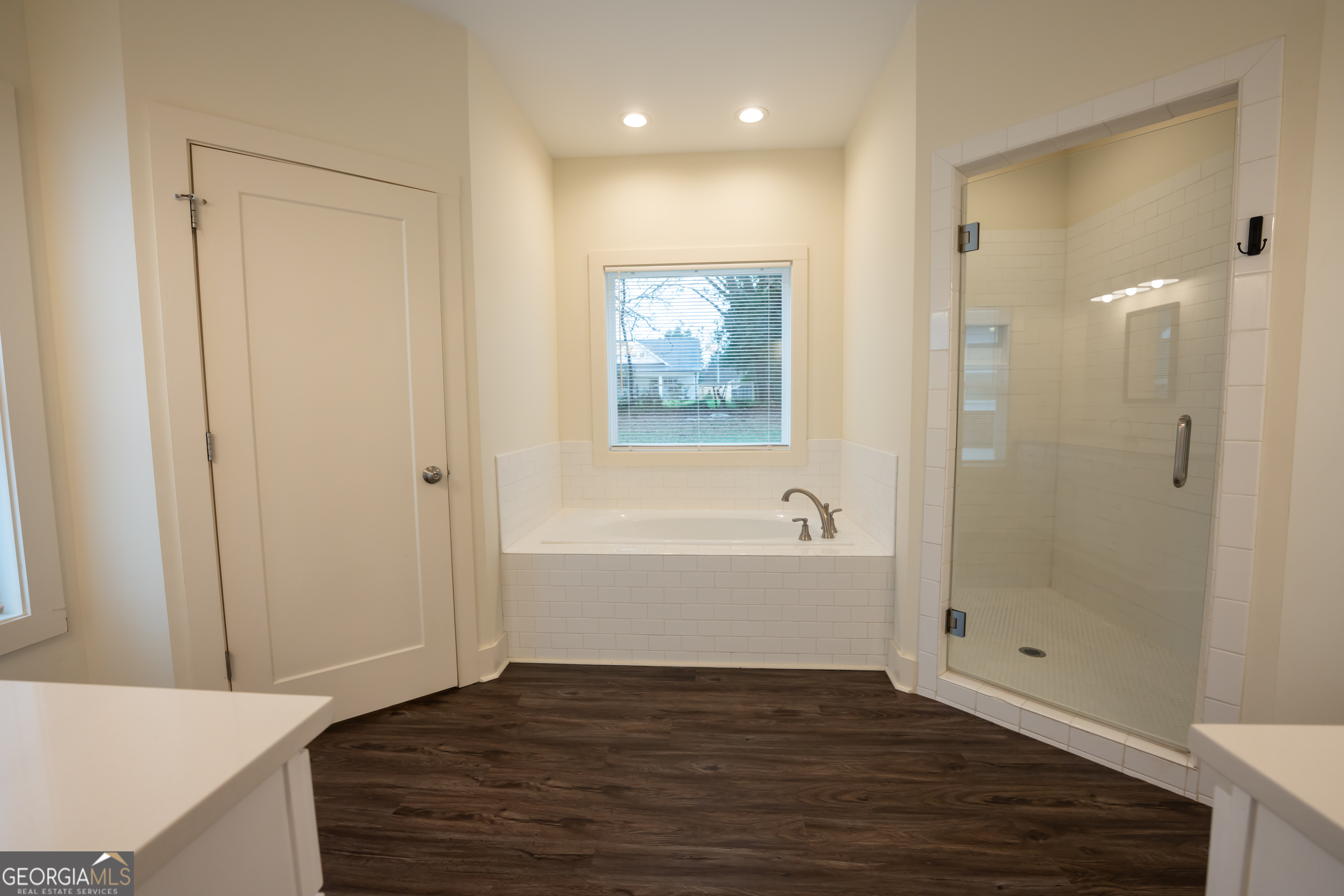1020 Bell Circle Madison, GA 30650 - Photo 10 of 17 a view of bathroom with bathtub wooden floor and windows