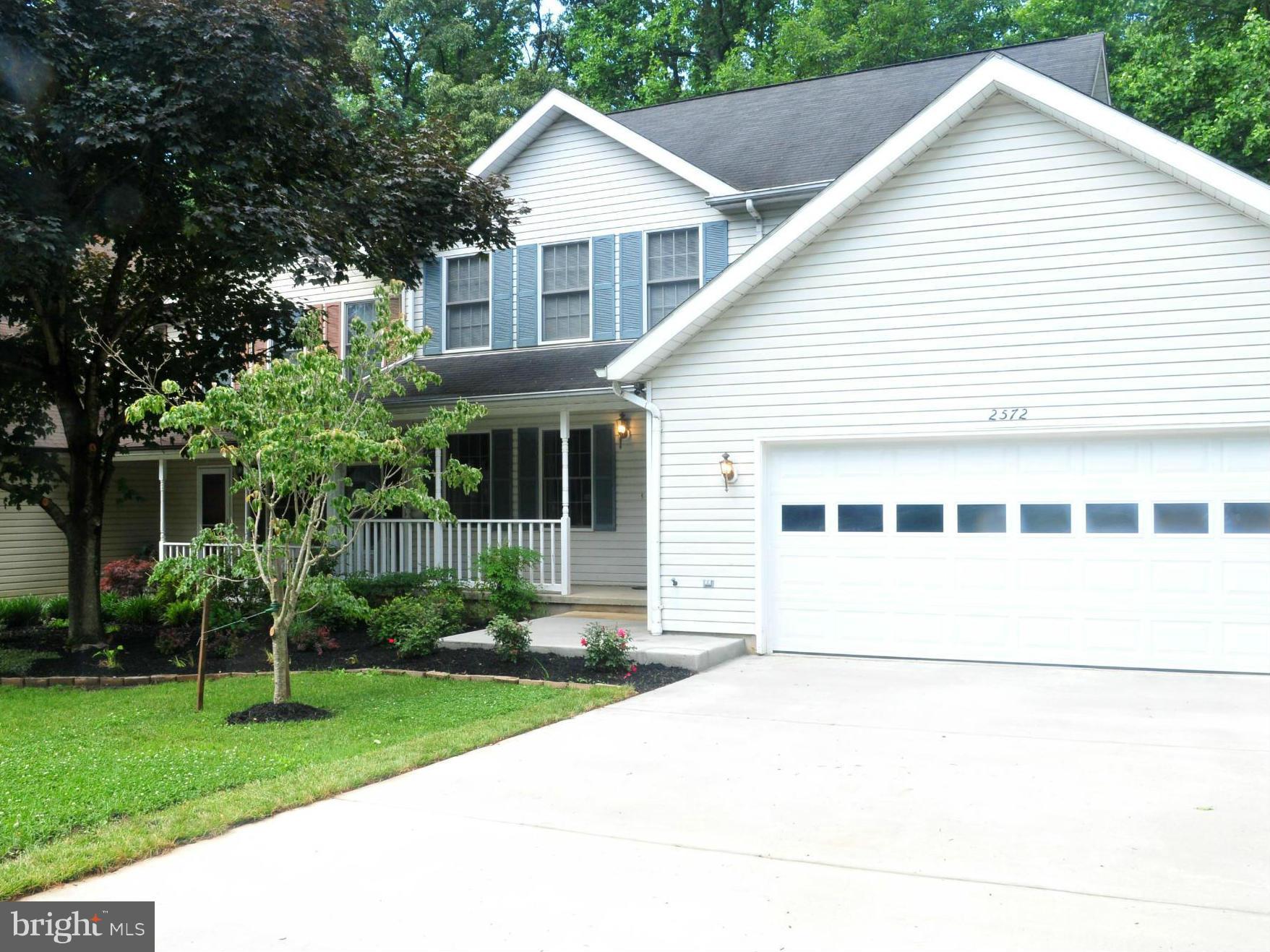 New Garage Door and Concrete Driveway