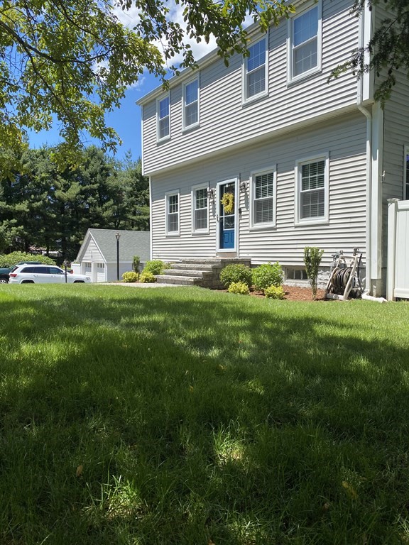 a front view of house with yard and green space