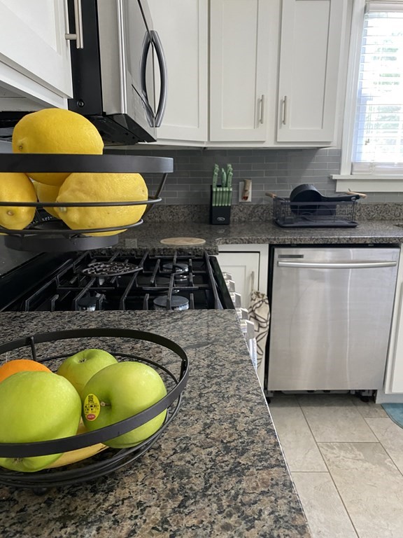 88 Fair Oak Road Springfield, MA 01128 - Photo 18 of 34 a kitchen with a sink a stove and cabinets