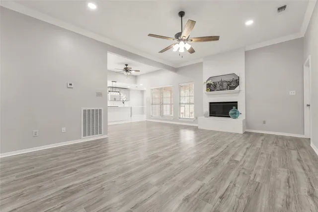 a view of a kitchen with wooden floor and a window