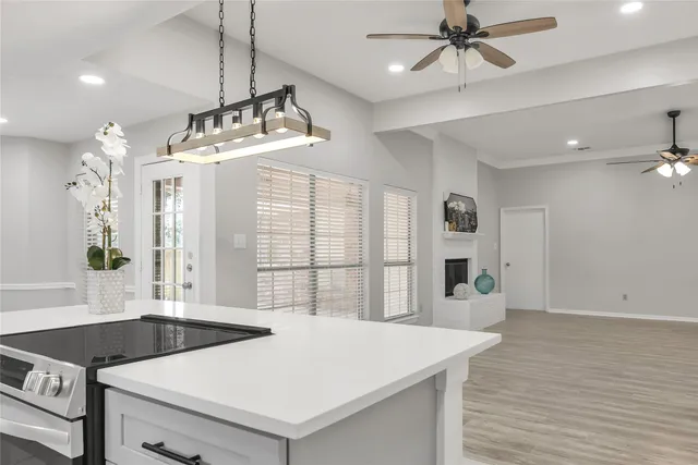 a kitchen with granite countertop a sink a counter space and stainless steel appliances