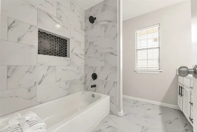 a view of a backyard with brick wall and plants