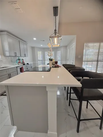 a kitchen with a table chairs microwave and cabinets