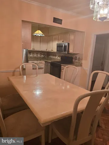 a view of a dining room with furniture and chandelier
