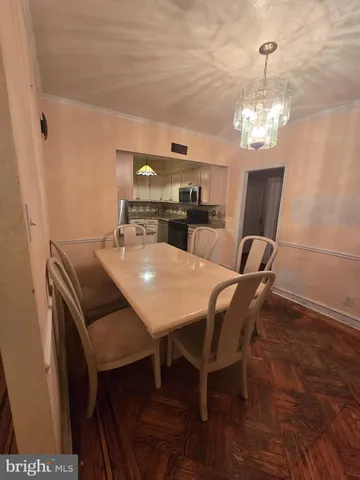 a dining room with furniture and chandelier