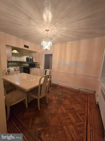 a view of a dining room with furniture and chandelier