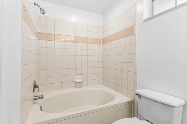 a white bath tub sitting next to a white toilet