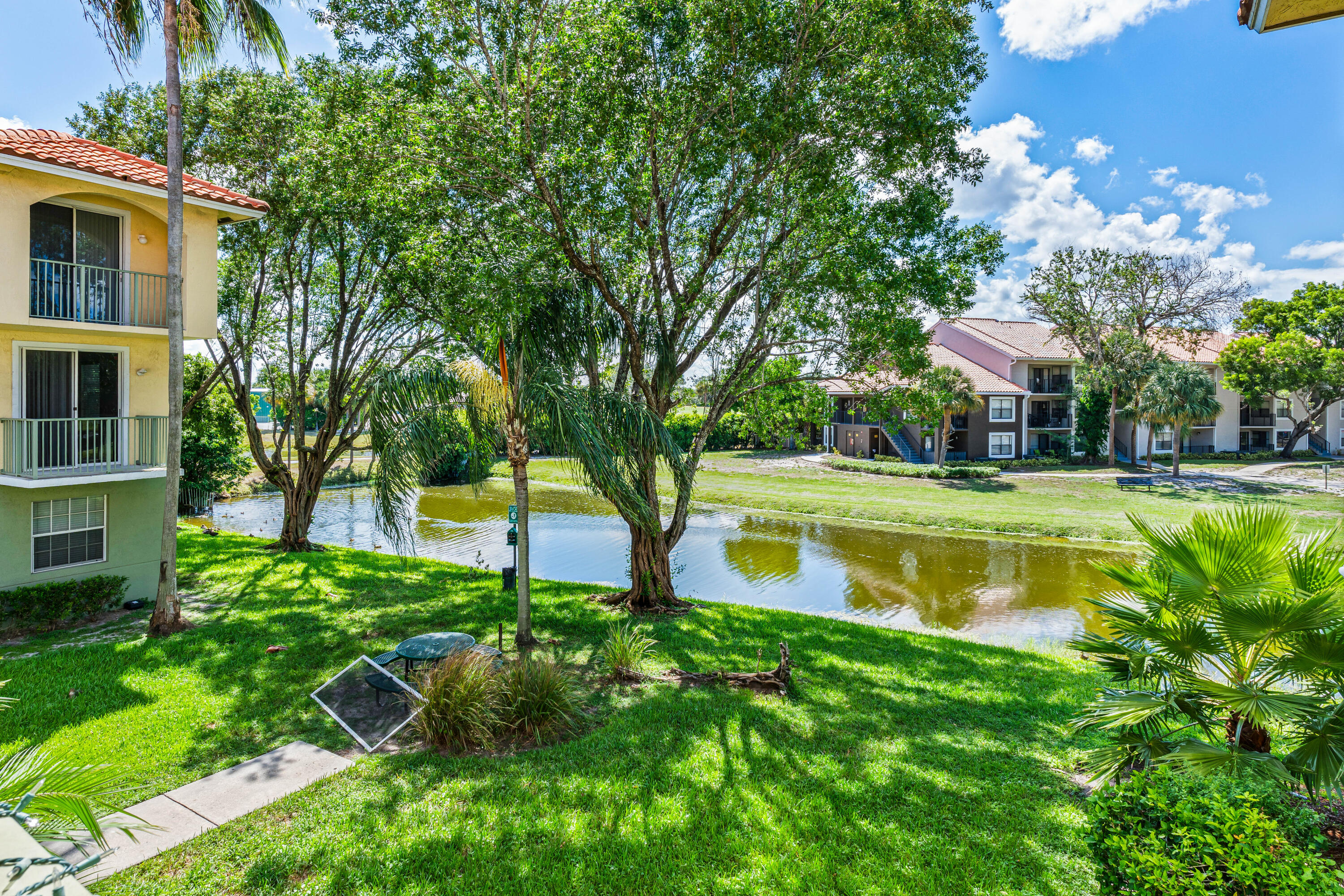 1951 Brandywine Road East, Unit 77105 West Palm Beach, FL 33409 - Photo 14 of 35 a view of a house with a swimming pool