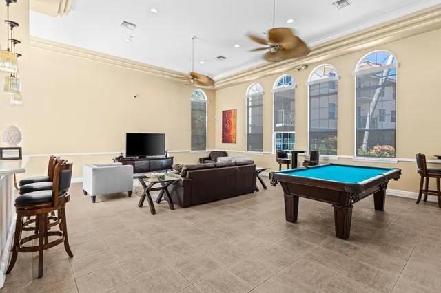 a view of a white house with a yard and sitting area