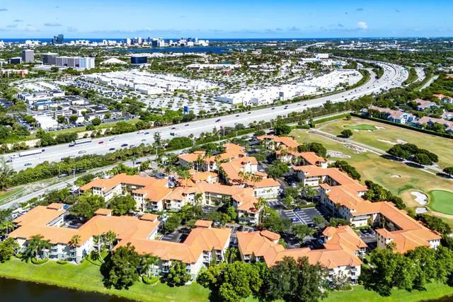 an aerial view of residential houses with outdoor space and lake view