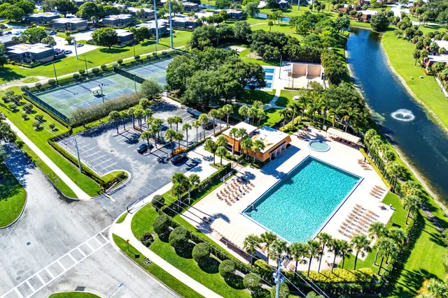 an aerial view of a house with a swimming pool yard and outdoor seating