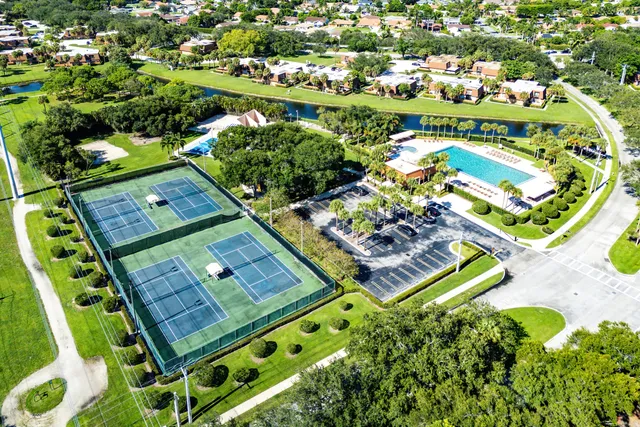 an aerial view of a residential houses with outdoor space and swimming pool