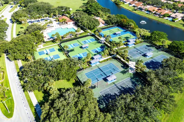 an aerial view of residential houses with outdoor space and lake view