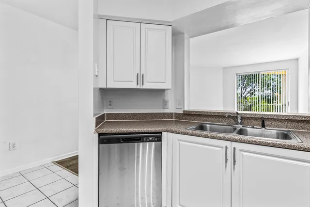 a kitchen with granite countertop a sink and a stove