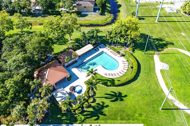 a view of a swimming pool with a yard
