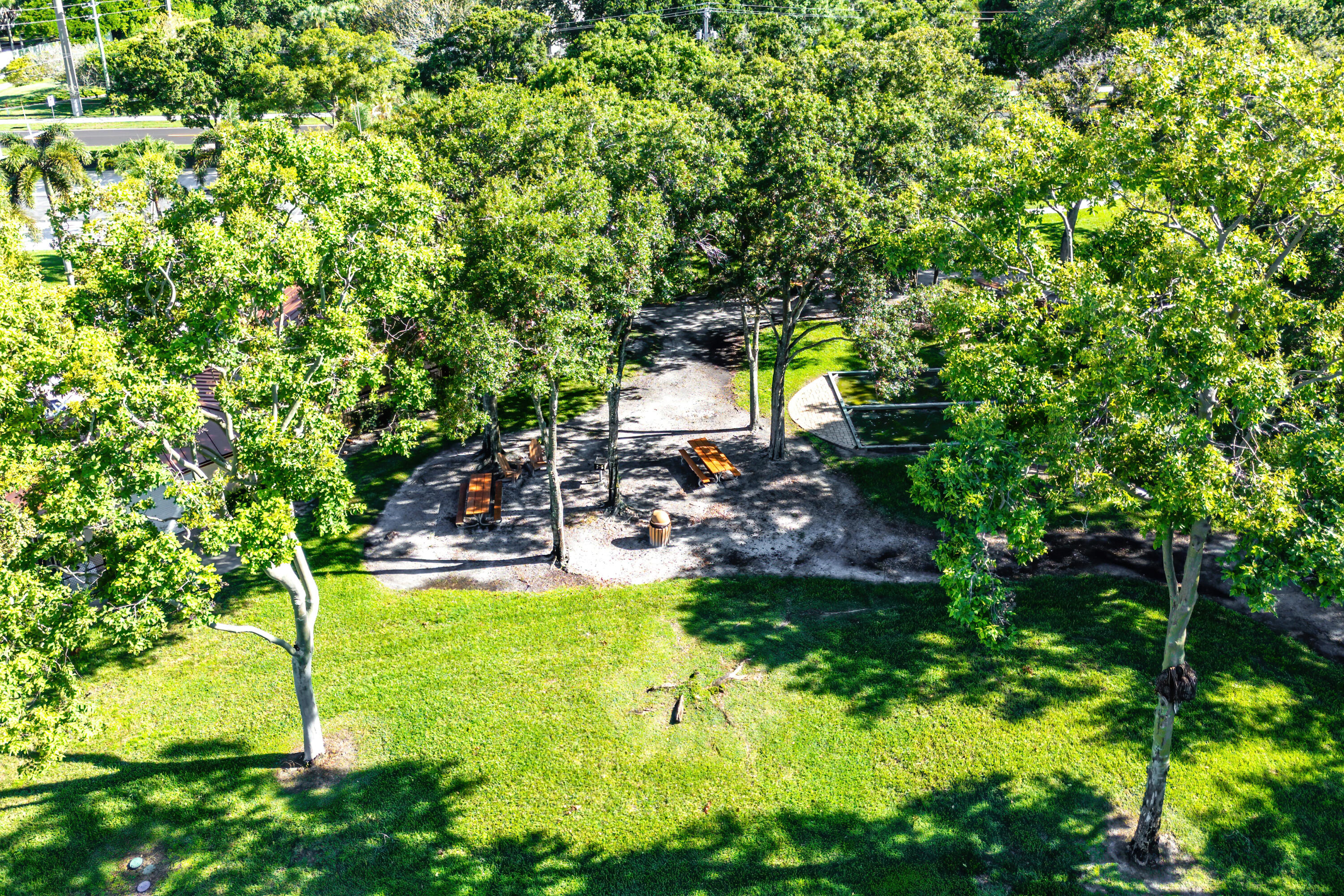 1951 Brandywine Road East, Unit 77105 West Palm Beach, FL 33409 - Photo 33 of 35 a view of a patio with table and chairs and potted plants