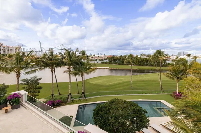 a view of a hall way with furniture and floor to ceiling window