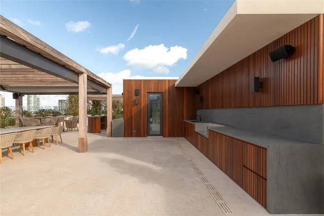a view of a patio with a table and chairs